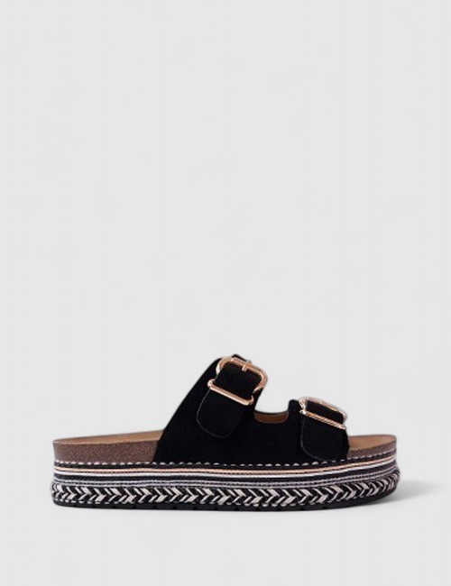 Cette image contient Mules noires à brides ajustables chez Joliesse. à 79,99 TND en Tunisie. L'hexa de l'arrière plan est #E7E7E