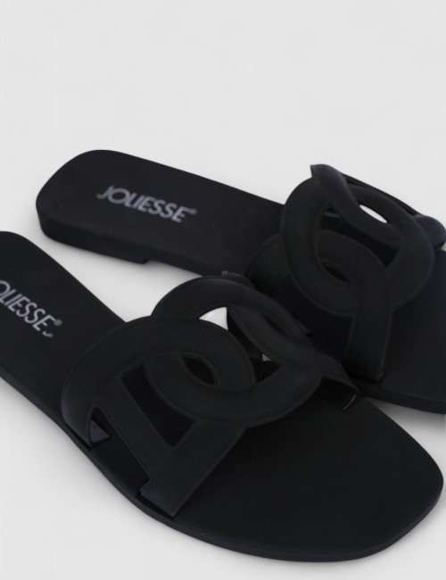 Cette image contient Mules plates noires design en silicone chez Joliesse. à 0,00 TND en Tunisie. L'hexa de l'arrière plan est #