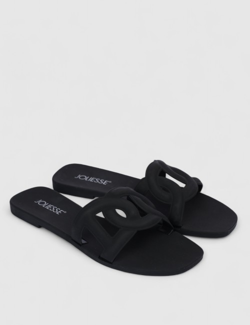 Cette image contient Mules plates noires design en silicone chez Joliesse. à 0,00 TND en Tunisie. L'hexa de l'arrière plan est #