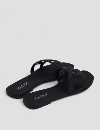 Cette image contient Mules plates noires design en silicone chez Joliesse. à 0,00 TND en Tunisie. L'hexa de l'arrière plan est #