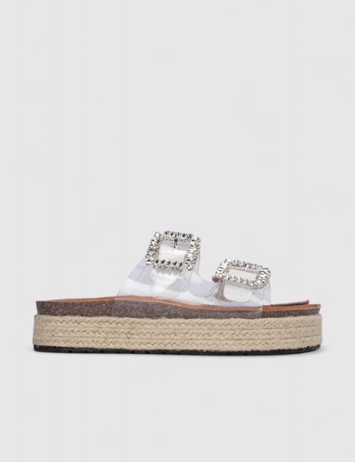 Cette image contient Mules transparentes à boucle brillante et semelle corde chez Joliesse. à 0,00 TND en Tunisie. L'hexa de l'a