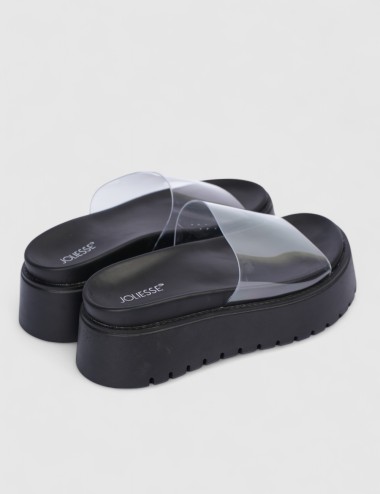 Cette image contient Mules compensées transparentes chez Joliesse. à 99,99 TND en Tunisie. L'hexa de l'arrière plan est #E7E7E7